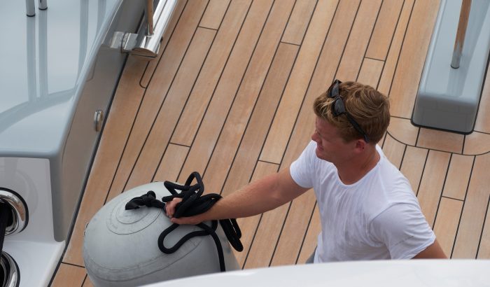 Deckhand working on deck of superyacht