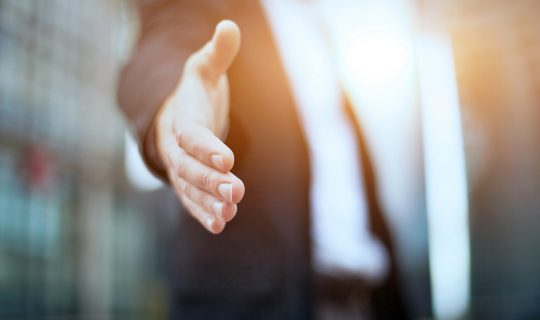 Man offering to shake hands on a deal